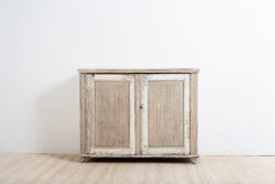 Provincial gustavian sideboard from Västerbotten in northern Sweden. Made around the year 1800. Fluted doors and angled corners with carved wooden decor. Dry scraped. Original working lock and key. 