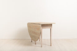 Gustavian drop leaf console table. The table is dry scarped to the original paint. Meant to stand against a wall or under a window