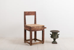 Combined folk art chair and table. The furniture is an example of compact living. The goal was to fit as many uses into the same item such as this combined chair and table