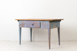Swedish country table with distressed blue paint from the late 1700s. The table which would work as both a wall or side table is from northern Sweden