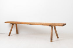 Wide folk art bench in solid pine. The bench is from the early 1800s and has an authentic patina after 200 years of use. The seat is one single board