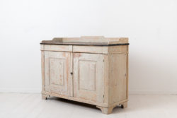 White gustavian sideboard from northern Sweden. The sideboard is from around 1790 and is in the gustavian style. The style got it's name from the Swedish king Gustav III