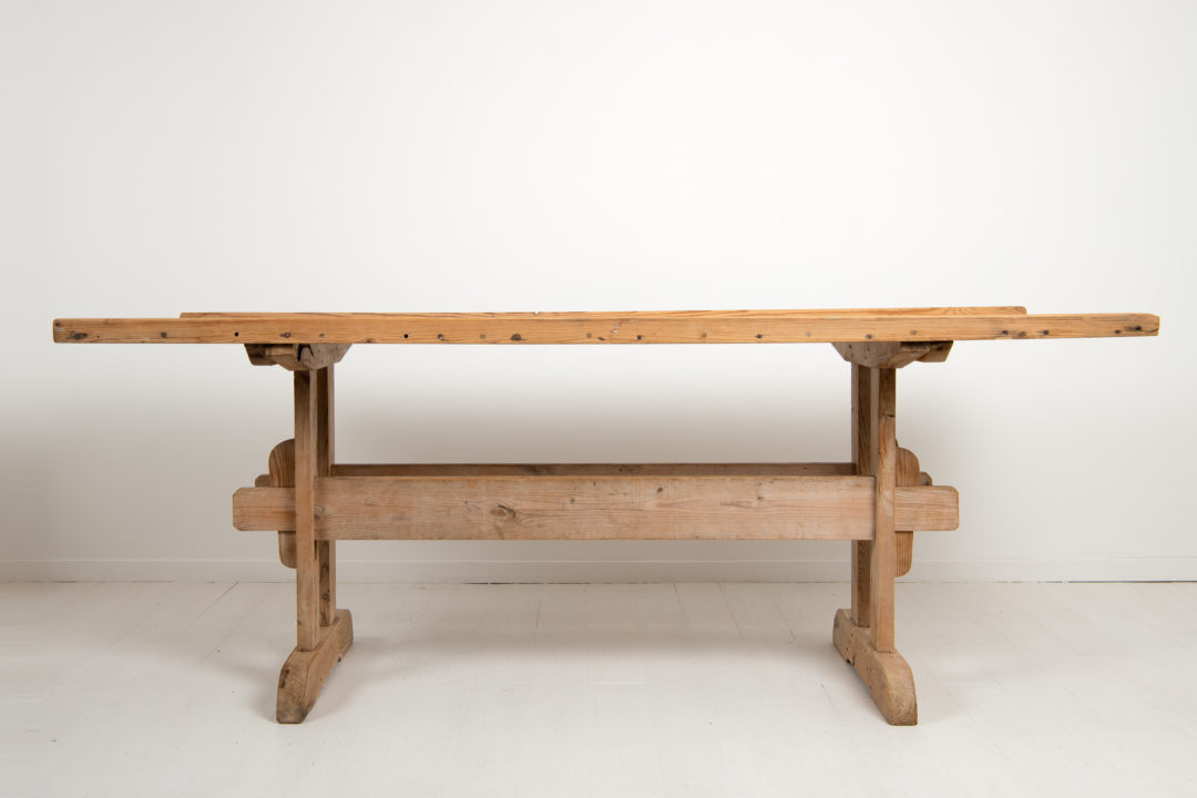 Country dining trestle table from Northern Sweden. The table is from the mid 19th century and made in pine with a solid table top .