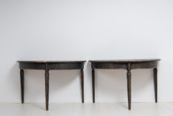 Black demi lune tables from northern Sweden made during the mid 19th century. The tables are from around 1860 and has black distressed paint