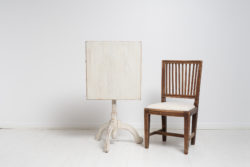 Tilt top column table made in pine from Northern Sweden. The table is charming in its simplicity with distressed white paint and rustic details.