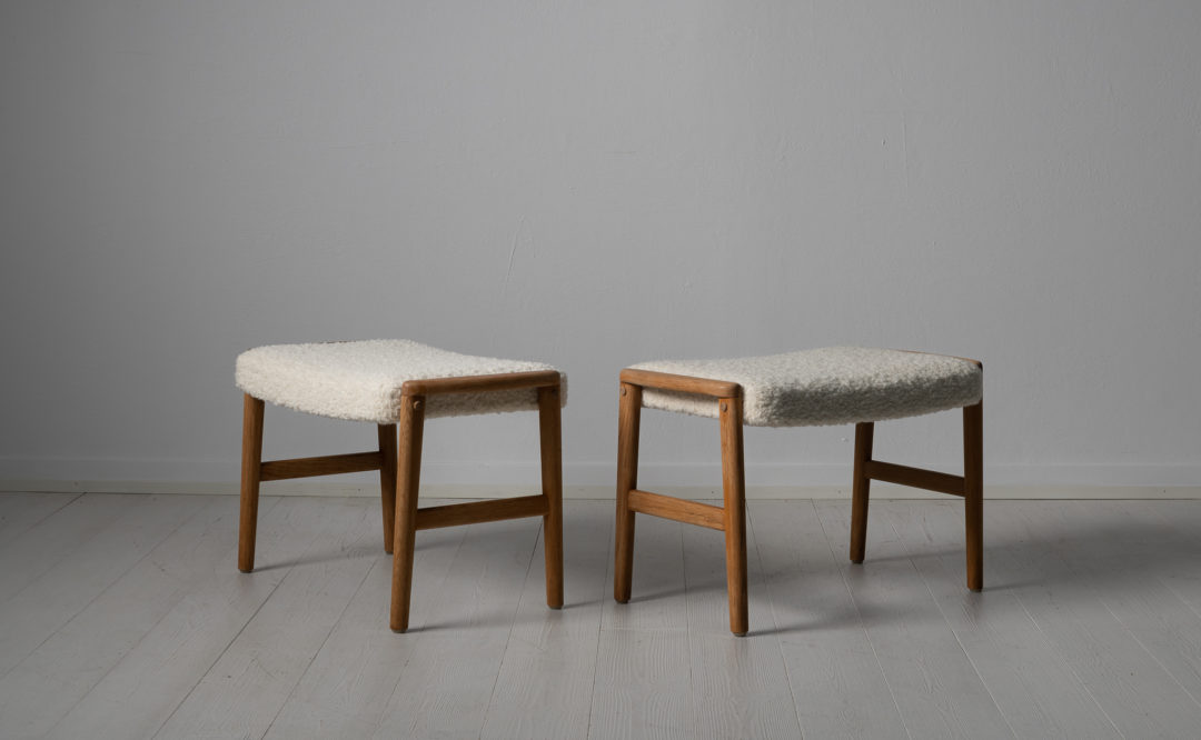 Scandinavian modern oak footstools from Sweden made around the 1960s. The stools are oak and newly upholstered. The cushions are upholstered with a special kind of white bouclé fabric