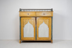 Country house empire sideboard from northern Sweden. The sideboard is from 1820 to 1840 and made in pine. It's an unusual model with a balustrade