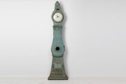 Antique long case clock from northern Sweden made during the late 1700s. The clock has the original blue-green paint with unusual decor