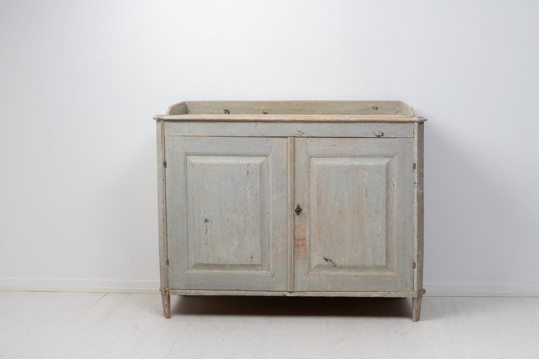 Rare antique gustavian sideboard from Northern Sweden made around 1780. The sideboard is made in painted pine and dry scraped by hand down to the original
