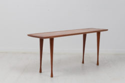 Scandinavian modern teak table from the mid 20th century, around 1960. The table is danish and has a thin and narrow shape.