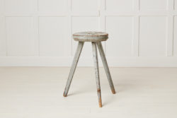 Antique Swedish rustic stool in folk art made with three legs. The stool has a round seat and is in its untouched original condition.