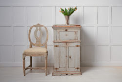 Antique Swedish tall sideboard in an unusually tall and narrow model with an uncommon function. Underneath the table top there is a large sugar hack attached