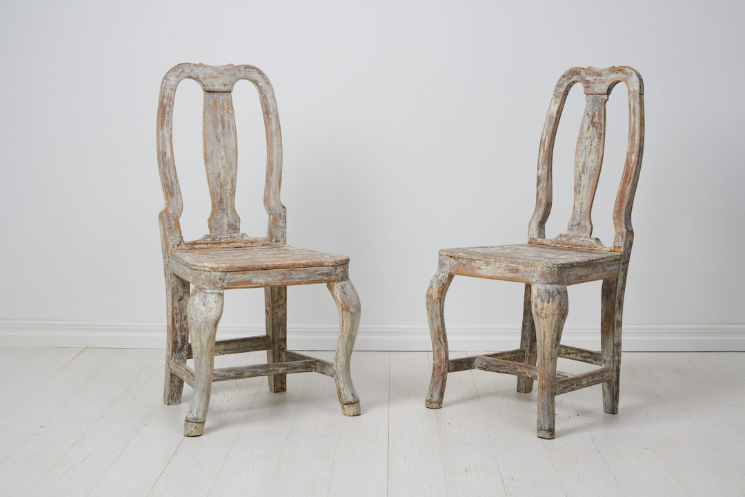 Pair of antique baroque chairs from the 1770s. The chairs are genuine Swedish country house furniture in solid pine from the late 1700s.