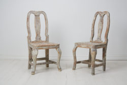 Pair of antique baroque chairs from the 1770s. The chairs are genuine Swedish country house furniture in solid pine from the late 1700s.