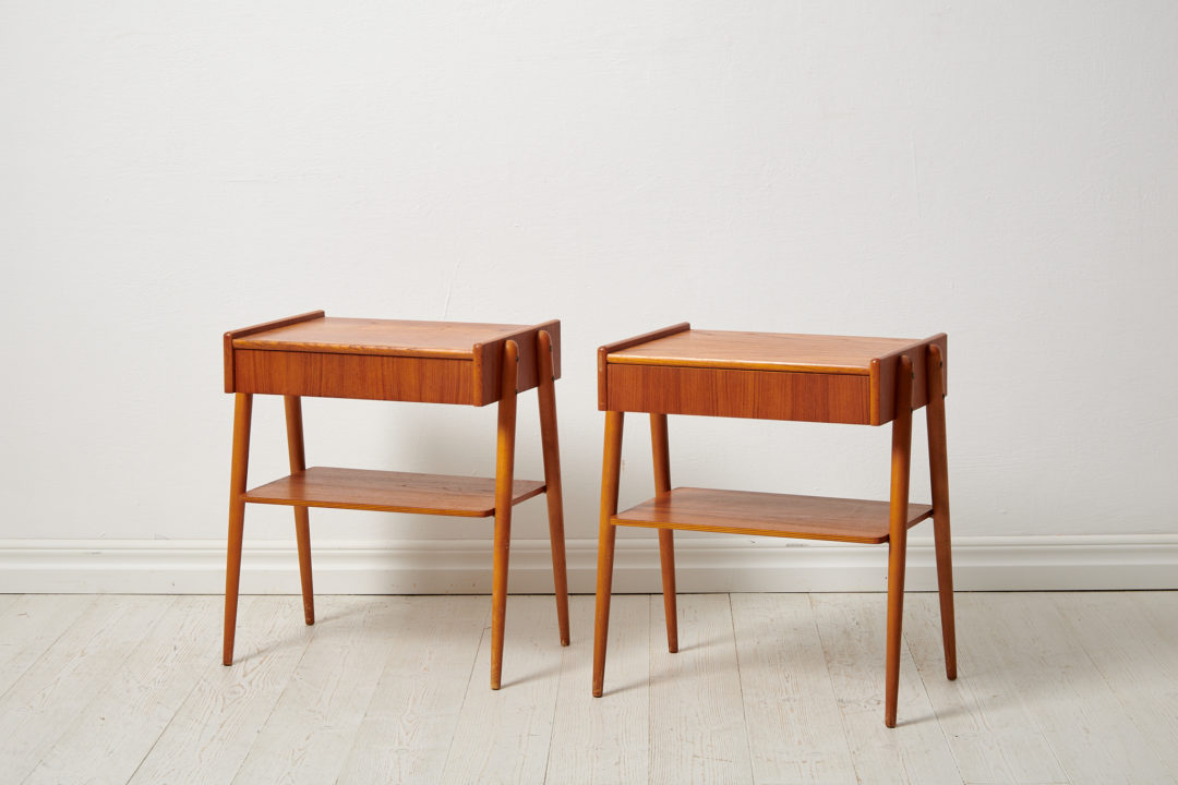 Swedish modern teak nightstands from the 1960s by Möbelfabriks AB, Carlssons & Co. The pair of nightstands have both a shelf and drawer.