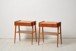 Swedish modern teak nightstands from the 1960s by Möbelfabriks AB, Carlssons & Co. The pair of nightstands have both a shelf and drawer.