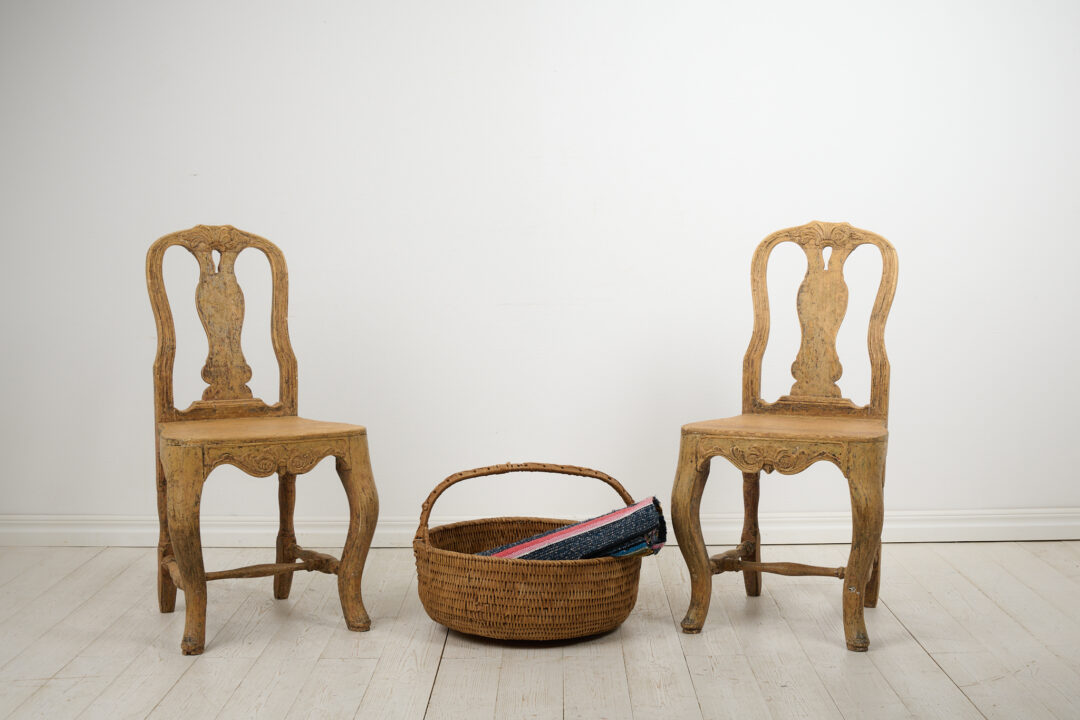 Pair of classic rococo chairs from the late 1700s. The pair of antique Swedish chairs is from northern Sweden and an authentic country furniture.