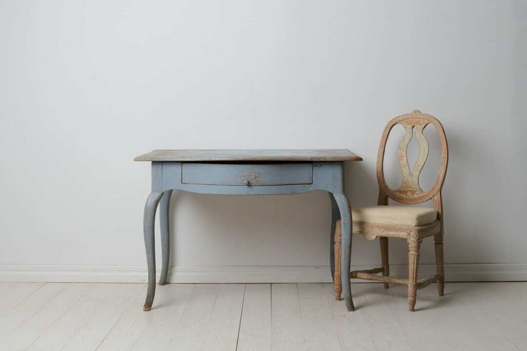 Antique Swedish rococo desk from the late 1700s. The desk is a country house furniture in rococo style with a large drawer. Heavily curved rococo legs