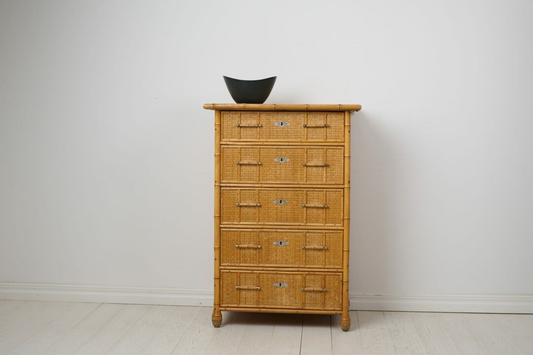 Antique Swedish chest of drawers in colonial style. The chest is tall and narrow with five drawers. The frame is made from solid Swedish pine