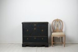 Antique Swedish chest of drawers in empire style from around 1840. The chest is made by hand in solid pine with three large, functional drawers.