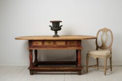 Unusual antique centre table or wall table from the baroque period. The table is a large oval table top on a frame with baluster legs