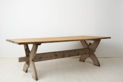 Large antique dining table or trestle table from northern Sweden made during the early 1800s. The table has a thick, solid table top