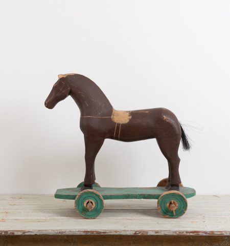 Antique toy horse in painted pine. The paint is original as is the condition. Manufactured in Sweden around 1880. One wheel is newer, most likely from the early 1900s. 