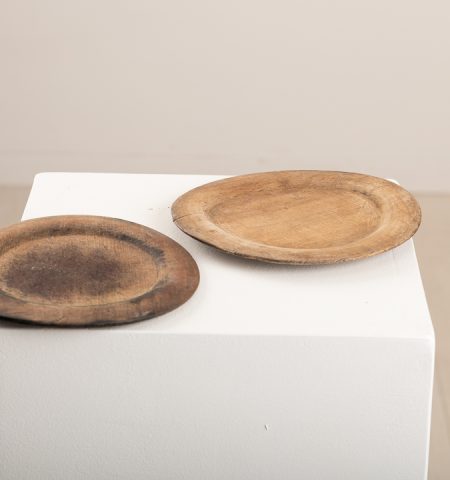 Wooden plates in a set of two. Made in northern Sweden the plates are from the mid 19th century. The markings underneath are house marks along with initials and years.