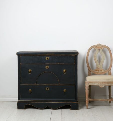 Antique Swedish chest of drawers in empire style from around 1840. The chest is made by hand in solid pine with three large, functional drawers.