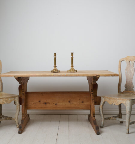 Swedish antique dining table or work table. The table is a genuine trestle table from northern Sweden made around 1820. The table has a large solid table top on a leg frame with bevelled trestles.