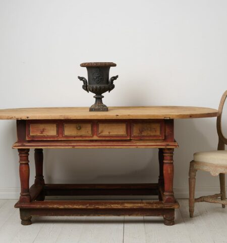 Unusual antique centre table or wall table from the baroque period. The table is a large oval table top on a frame with baluster legs