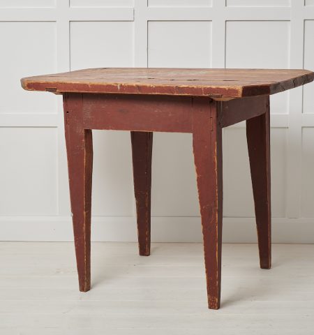Antique Swedish primitive table in folk art. The table is a country furniture with a simple construction and a charmingly primitive appearance