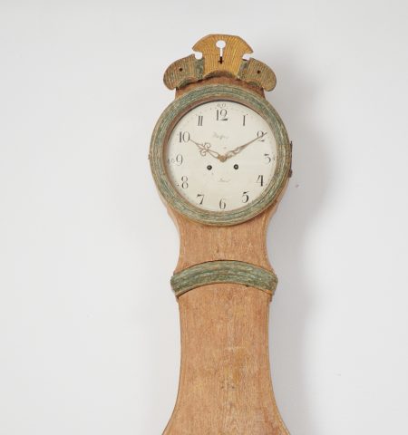 Classic long case clock in rococo shape from Sweden. The clock is made by hand from pine and has been hand-scraped down to the original paint