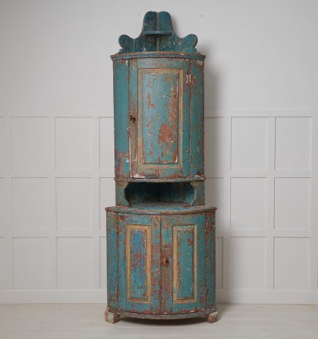 Antique Swedish corner cabinet. The cabinet is a genuine Swedish country house furniture from the early 1800s. Old historic and rustic paint