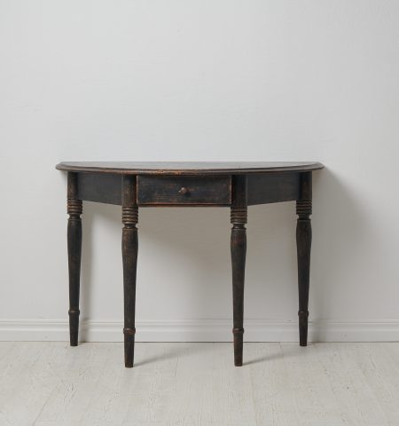 Antique Swedish console table or wall table. The table has a demi lune shape with four legs and a centered drawer in the apron.