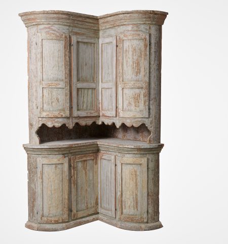Unusual antique corner cabinet from Sweden. The cabinet is made in two parts and has a very unusual model with a curved serpentine front with 4 + 4 doors.