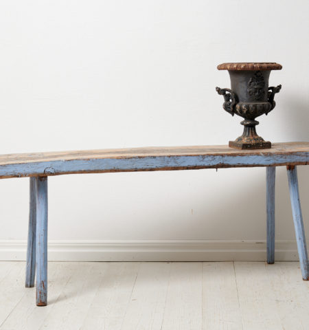 Discover a Swedish antique country bench—handmade in pine, adorned with aged paint and historic graffiti. Embrace unique charm and character.