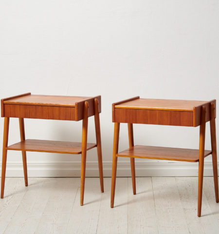 Swedish modern teak nightstands from the 1960s by Möbelfabriks AB, Carlssons & Co. The pair of nightstands have both a shelf and drawer.