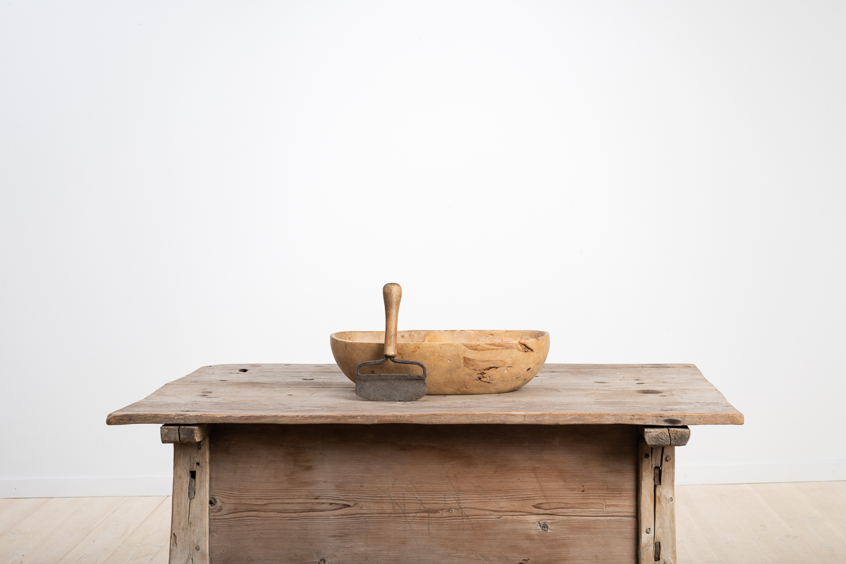 Wooden bowl with adjacent chopping knife in hand wrought iron