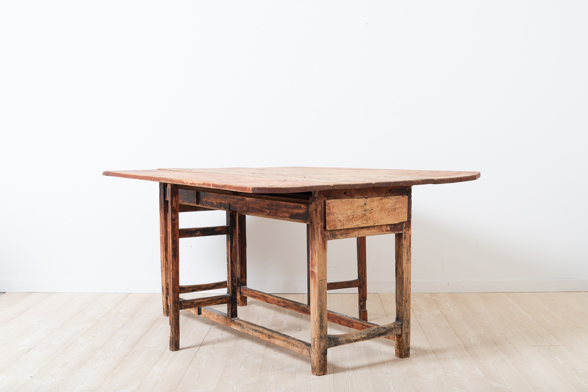 Folk art drop leaf table with drawer. Unusual model a long mid section and short drop leafs