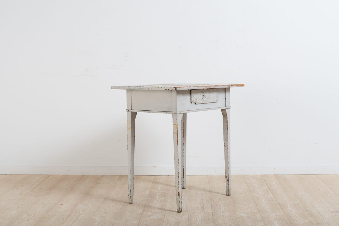 Gustavian side table with drawer. Historic paint from the mid 19th century and some wear due to use. The drawer has some smaller loss of material.