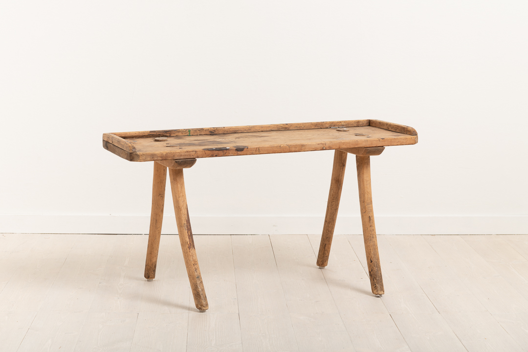 Primitive folk art stool in unpainted pine. Slightly curved legs made from branches. The branches' still have their natural slightly curved shape.