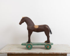 Antique toy horse in painted pine. The paint is original as is the condition. Manufactured in Sweden around 1880. One wheel is newer, most likely from the early 1900s. 