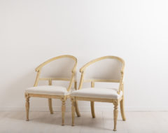 Barrel back chairs in Gustavian Style. Dry scarped by hand. Liberally decorated with wooden carvings, on both front legs and further up along the back