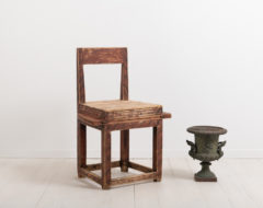 Combined folk art chair and table. The furniture is an example of compact living. The goal was to fit as many uses into the same item such as this combined chair and table