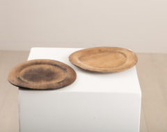 Wooden plates in a set of two. Made in northern Sweden the plates are from the mid 19th century. The markings underneath are house marks along with initials and years.