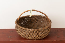 Folk art woven basket from the late 19th century. The basket has some minor signs of wear but is otherwise in good antique condition. For more Miscellaneous