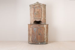 Rococo corner cabinet from around 1770. Made in Northern Sweden the cabinet is in two parts with rustic patina and original blue paint