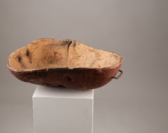 Unusually large wooden bowl with organic shape. The bowl is folk art and made from birch root. The red paint underneath is original to the bowl.