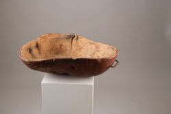 Unusually large wooden bowl with organic shape. The bowl is folk art and made from birch root. The red paint underneath is original to the bowl.